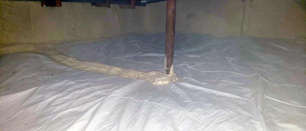 Photo of a crawlspace after encapsulation services provided by Chem-Tech showing how the plastic sheeting and foam sealant seals the space.